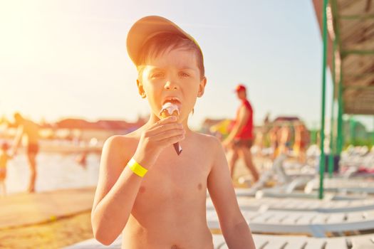 Baby boy with ice-cream at the beach