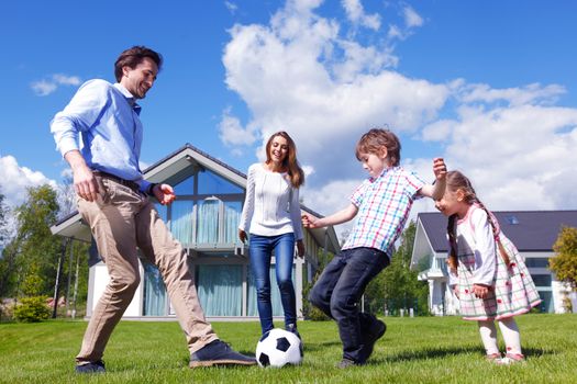 family playing football in front of their house