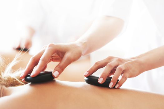 woman having stone therapy at spa session