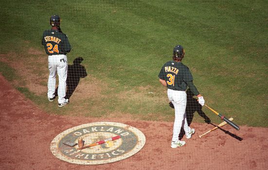 Mike Piazza and Shannon Stewart on deck during an A's baseball game at Oakland Coliseum.