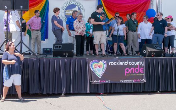 Nyack, NY, USA - June 14, 2015: Rockland County Pride. Group of officials and community leaders on the stage. Sign-language translator before the stage.