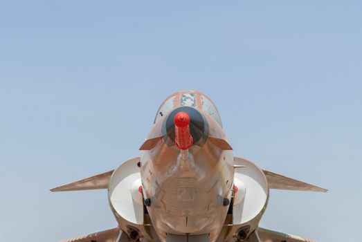 Fighter aircraft nose and cabin detail with blue sky background