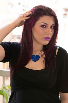 Portrait of a young beautiful Caucasian girl with purple hair.