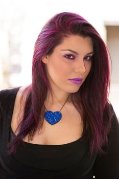 Portrait of a young beautiful Caucasian girl with purple hair.
