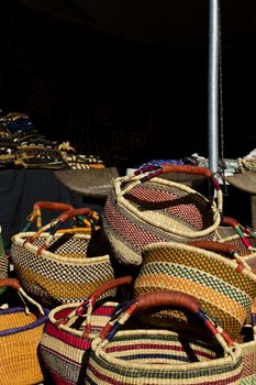 Colorful, woven baskets piled high at African Art Village of popular Tucson Gem and MIneral Show in Tucson, Arizona.  