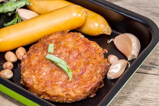 pork fried and  sausages in pan 