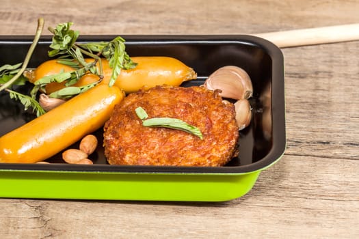 pork fried and  sausages in pan 