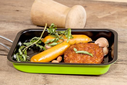 pork fried and  sausages in pan 