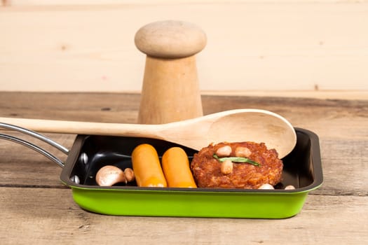 pork fried and  sausages in pan 