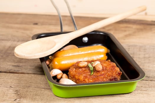 pork fried and  sausages in pan 