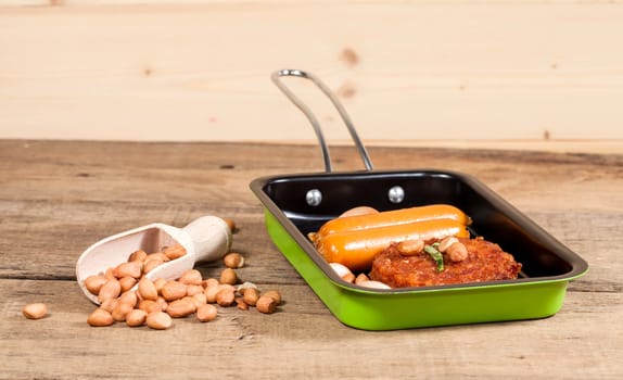 pork fried and  sausages in pan 