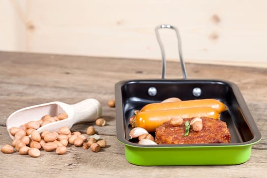 pork fried and  sausages in pan 