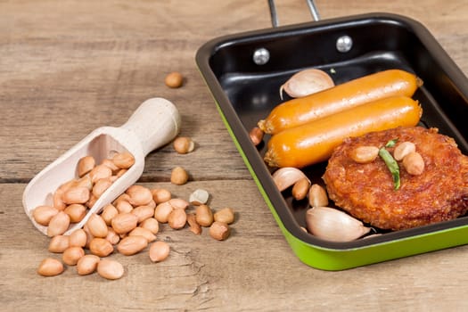 pork fried and  sausages in pan 