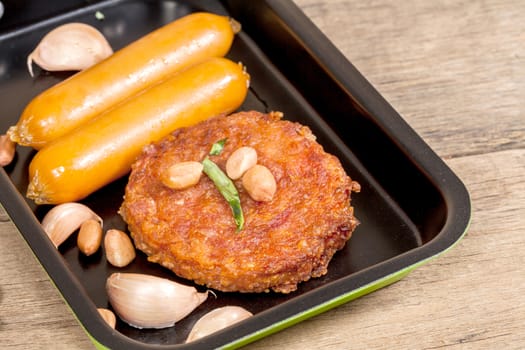pork fried and  sausages in pan 