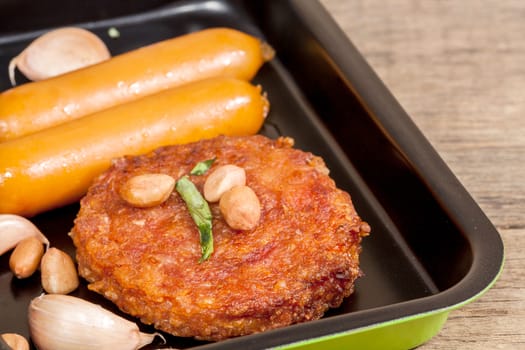 pork fried and  sausages in pan