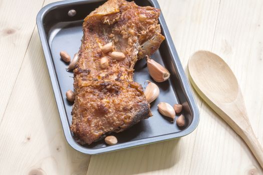 fish fillet fried in the pan on wood