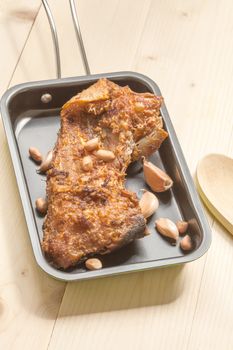 fish fillet fried in the pan on wood