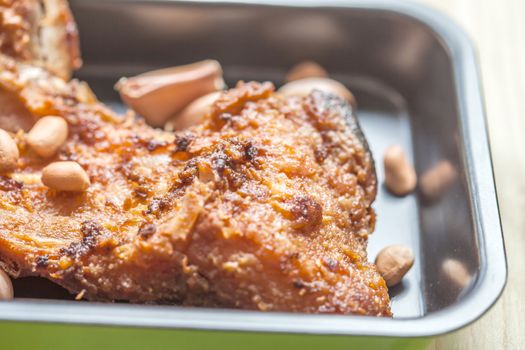 fish fillet fried in the pan on wood