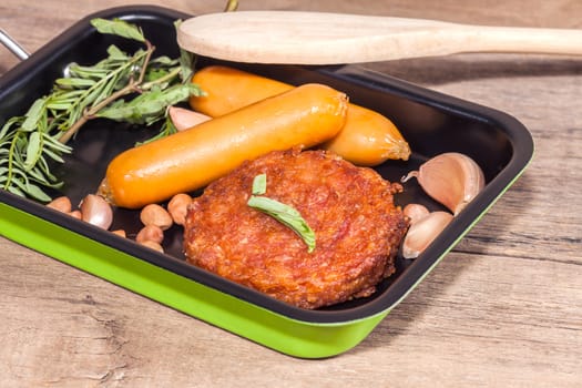 pork fried and  sausages in pan 