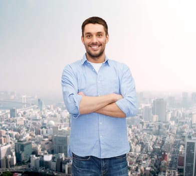 happiness and people concept - smiling man with crossed arms