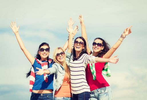 summer, holidays, vacation, happy people concept - beautiful teenage girls or young women having fun on the beach