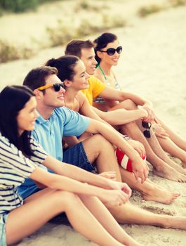 summer, holidays, vacation, happy people concept - group of friends or volleyball team having fun on the beach