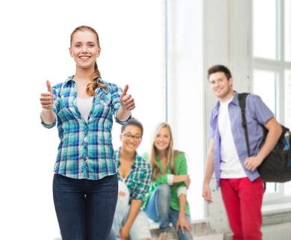 education concept - young woman in casual clothes showing thumbs up