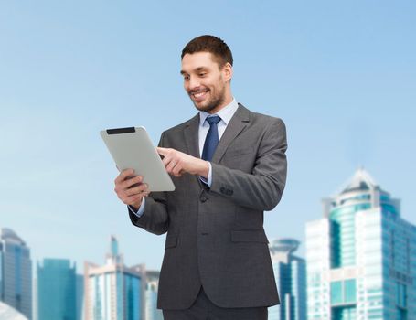 business and technology concept - smiling businessman with tablet pc computer