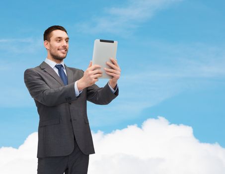 business and technology concept - smiling businessman with tablet pc computer