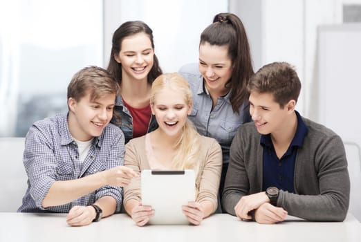 education, technology and internet concept - smiling students with tablet pc at school