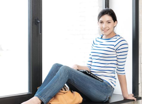 education and technology concept - happy and smiling teenage girl with laptop