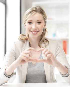 business concept - young woman showing heart sign