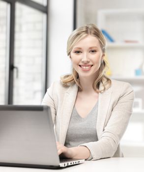 business and technology concept - happy woman with laptop computer