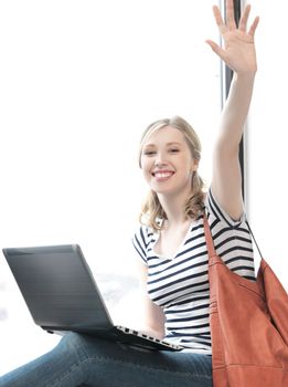 education and technology concept - happy teenage girl waving a greeting with laptop