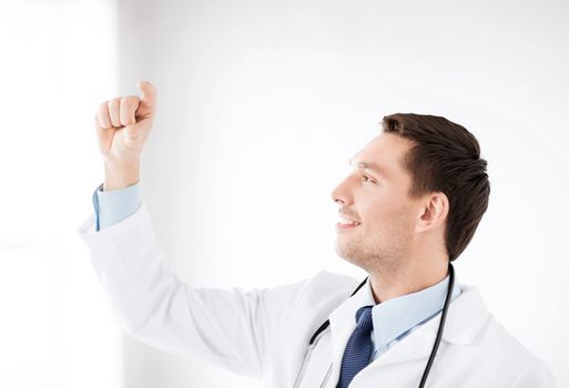 healthcare, medical and technology - young doctor holding something imaginary