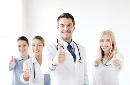 healthcare and medical - professional young team or group of doctors showing thumbs up