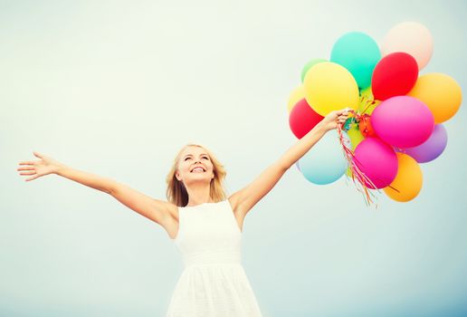 summer holidays, celebration and lifestyle concept - beautiful woman with colorful balloons outside