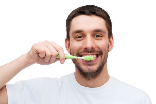 health and beauty concept - smiling young man with toothbrush