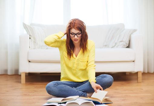 education concept - stressed student girl reading books at home