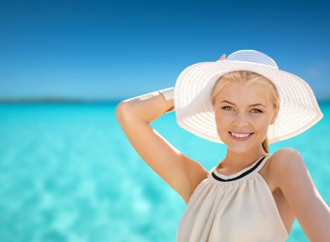 fashion, happiness and lifestyle concept - beautiful woman in hat enjoying summer outdoors