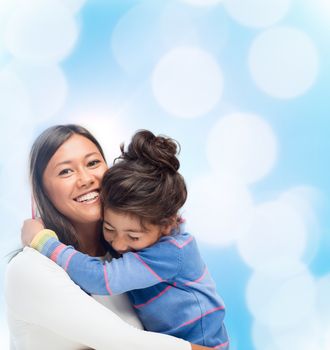 family, children and happy people concept - hugging mother and daughter