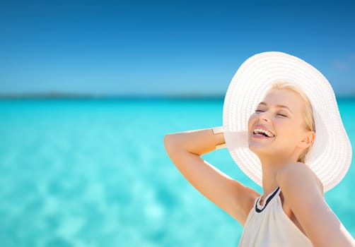 fashion, happiness and lifestyle concept - beautiful woman in hat enjoying summer outdoors