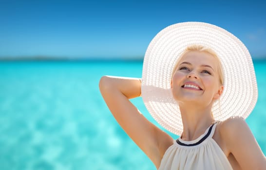 fashion, happiness and lifestyle concept - beautiful woman in hat enjoying summer outdoors