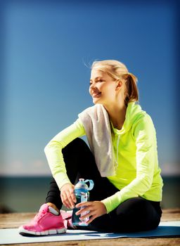 sport and lifestyle concept - woman resting after doing sports outdoors