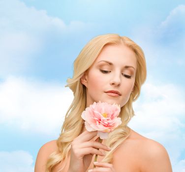 floral and beauty concept - lovely woman with peony flower