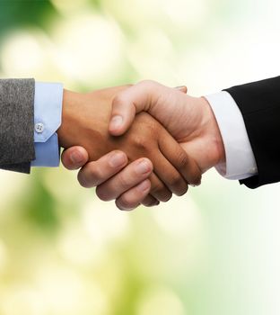 business and office concept - businessman and businesswoman shaking hands