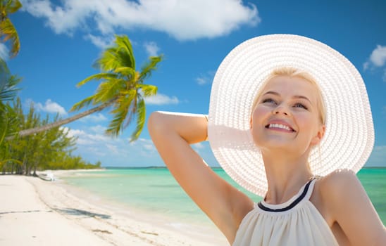 fashion, happiness and lifestyle concept - beautiful woman in hat enjoying summer outdoors