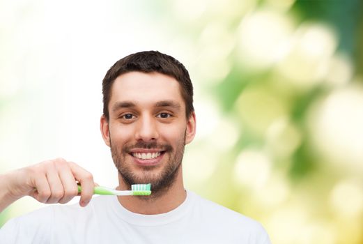 health and beauty concept - smiling young man with toothbrush
