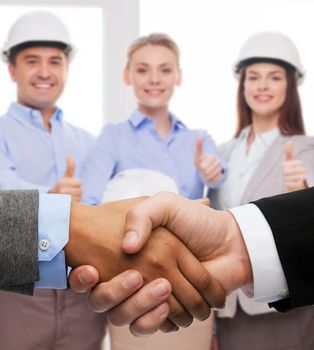 business and office concept - businessman and businesswoman shaking hands