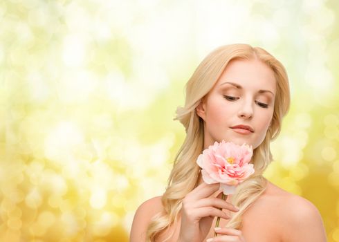 floral and beauty concept - lovely woman with peony flower